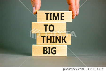 Time to think big symbol. Concept words Time to think big on beautiful wooden block. Beautiful grey table grey background. Businessman hand. Business and time to think big concept. Copy space. 114104414