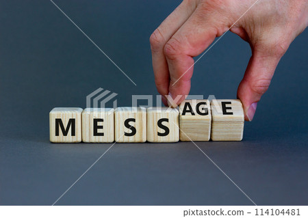 Make your mess your message symbol. Businessman turns cubes and changes the word 'mess' to 'message'. Beautiful grey background, copy space. Business and make your mess your message concept. Make your mess your message symbol. Businessman turns cubes and changes the word 'mess' to 'message'. Beautiful grey background, copy space. Business and make your mess your message concept. 114104481
