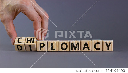 Diplomacy or chiplomacy symbol. Businessman turns cubes and changes the concept word diplomacy to chiplomacy. Beautiful grey table grey background,copy space. Business diplomacy or chiplomacy concept. Diplomacy or chiplomacy symbol. Businessman turns cubes and changes the concept word diplomacy to chiplomacy. Beautiful grey table grey background,copy space. Business diplomacy or chiplomacy concept. 114104490