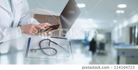 Doctor working in office on computer and phone . 114104723