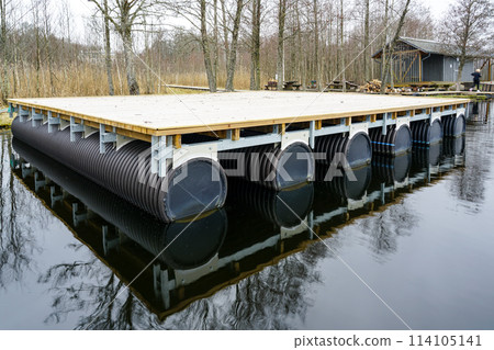 A new empty wooden platform on pontoons in the lake for the creation of a holiday house on the water 114105141