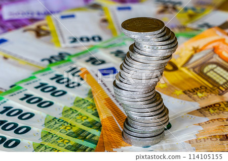 Unstable stack of euro coins on the euro banknotes background, unstable future balance concept Unstable stack of euro coins on the euro banknotes background, unstable future balance concept 114105155