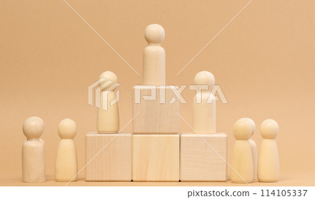 Wooden figures of men stand on a pedestal. The concept of rivalry in sports, business and life. Achieving success 114105337