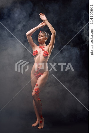 Sensual naked woman with petals and smoke in studio 114105661