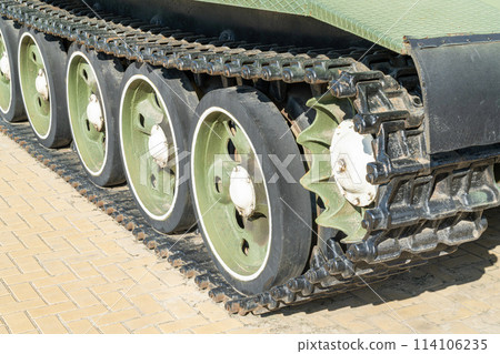 a green tank track in close-up on the asphalt a green tank track in close-up on the asphalt 114106235
