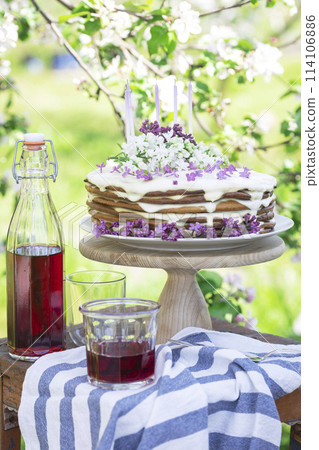 beautiful cake with candles on the background of nature 114106886