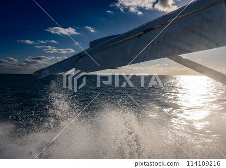 Swirling mist and water droplets caused by seaplane taking off from the ocean Swirling mist and water droplets caused by seaplane taking off from the ocean 114109216