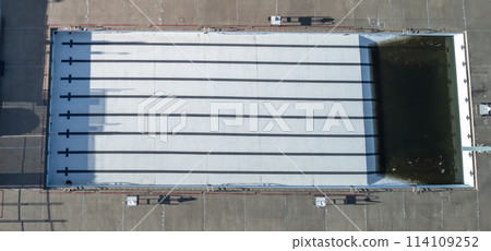 Drone view of an empty and drained winterized swimming pool  114109252
