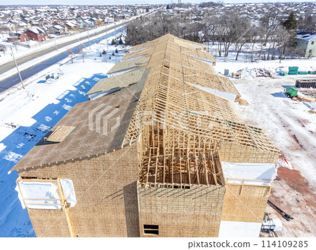 Aerial drone view of a multifamily apartment complex under construction. 114109285