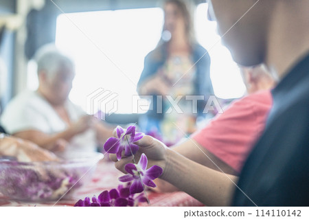 Young people experiencing orchid lei making in Waikiki, Hawaii Young people experiencing orchid lei making in Waikiki, Hawaii 114110142