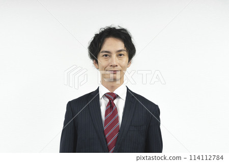 A man in a suit looking at camera A man in a suit looking at camera 114112784