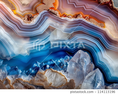 A close-up of a colorful, layered mineral geode with sharp crystal formations. A close-up of a colorful, layered mineral geode with sharp crystal formations. 114113196