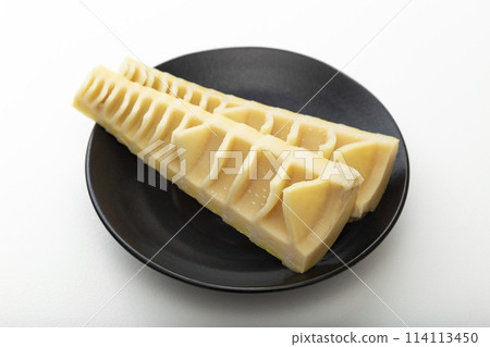 Bamboo shoots on a black plate on a white background 114113450