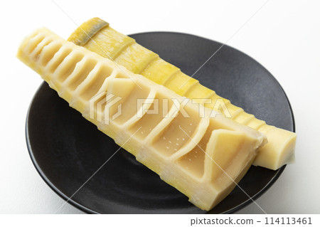 Bamboo shoots on a black plate on a white background Bamboo shoots on a black plate on a white background 114113461