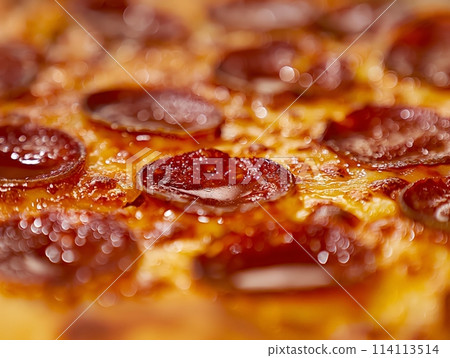 Macro shot highlighting the texture of gooey melted cheese and spicy pepperoni on pizza, evoking appetite and warmth. 114113514