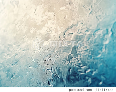 Close-up of water droplets on glass creating a refreshing, textured pattern with a soft gradient of blue tones. 114113528