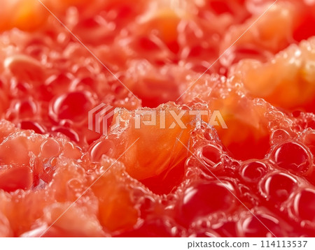 Macro shot highlighting the vibrant texture of tomato sauce, focusing on the glossy surface and rich color. 114113537