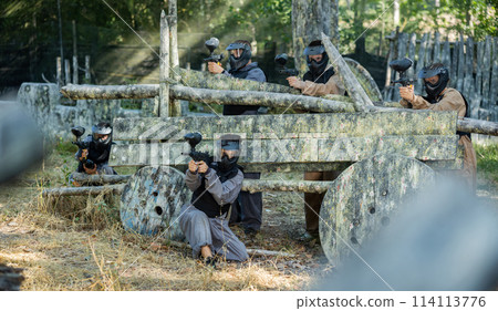 Team eliminating opponents on paintball field 114113776