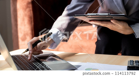Businesswoman bookkeeper hand holding pen and use calculator, laptop analysis the graph for Setting challenging business goals and ready to achieve target at home office Businesswoman bookkeeper hand holding pen and use calculator, laptop analysis the graph for Setting challenging business goals and ready to achieve target at home office 114113792