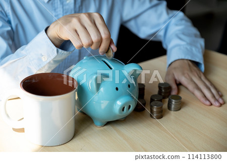 woman hand putting gold coin into pink piggy bank and use laptop for online marketing, step up start up business to suscess, Saving money for future plan and retirement fund concept woman hand putting gold coin into pink piggy bank and use laptop for online marketing, step up start up business to suscess, Saving money for future plan and retirement fund concept 114113800