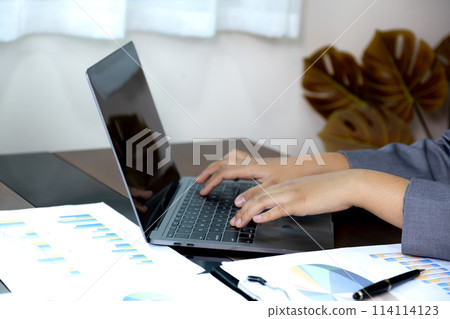 Businesswomen bookkeeper hand use laptop analysis the graph for Setting challenging business goals and ready to achieve target at home office 114114123
