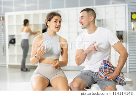 Man and two women talking in locker room Man and two women talking in locker room 114114148