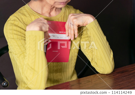 Senior woman living on pension worries about bankbook Senior woman living on pension worries about bankbook 114114249