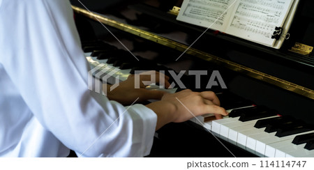 Close-up of pianist hand playing piano, player practice music according to the song's key 114114747