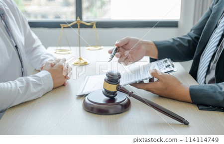 Judges gavel standing in front of the male lawyer is providing service to consult business dispute Judges gavel standing in front of the male lawyer is providing service to consult business dispute 114114749