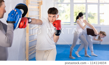 Two men training boxing fight in studio Two men training boxing fight in studio 114114834