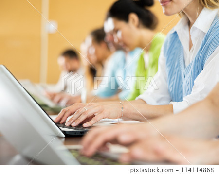 Side view of group of adult students in university classroom 114114868