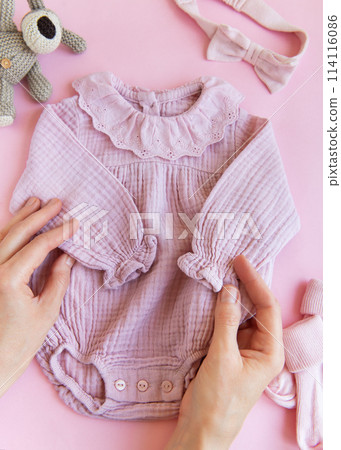 Pink  bodysuit with toy knitted dog, socks and headband. 114116086