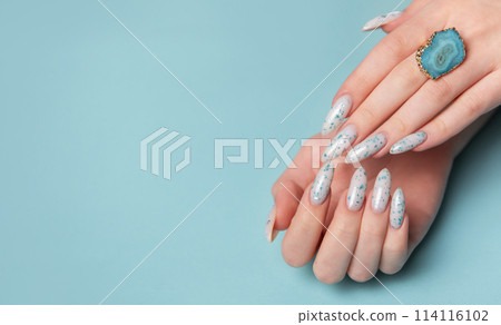 Female hands with blue nail design. Blue nail polish manicure. 114116102