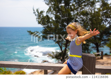 Child hiking. Sea and mountain view. Kids hike. 114116696