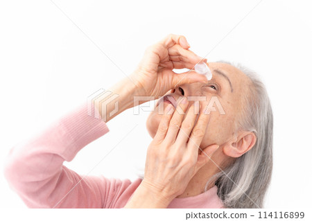 Senior woman pointing eye drops 114116899