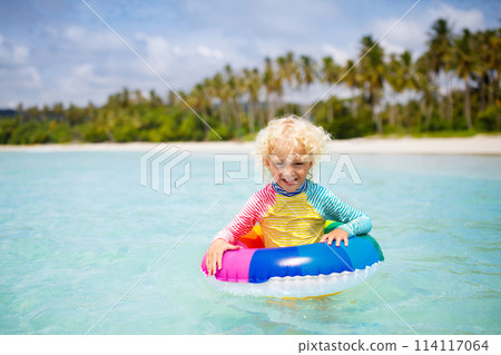 Child on tropical beach. Sea vacation with kids. 114117064