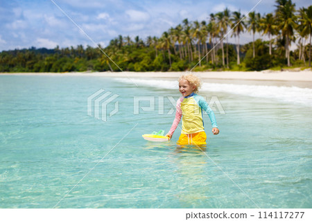 Child on tropical beach. Sea vacation with kids. 114117277