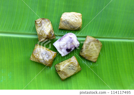 Bundled boiled sticky rice with banana and black beans wrapped in banana leaves Bundled boiled sticky rice with banana and black beans wrapped in banana leaves 114117495
