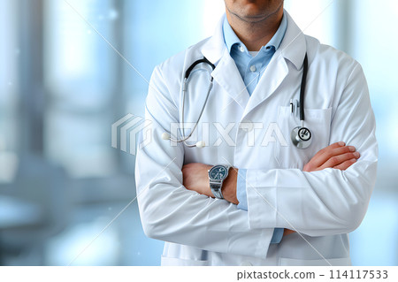 Doctor in workwear with arms crossed and stethoscope around neck 114117533