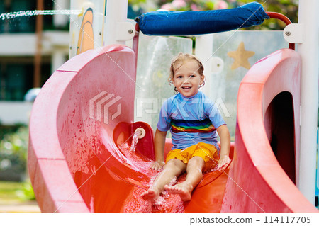 Kids on water slide in aqua park. Summer vacation 114117705