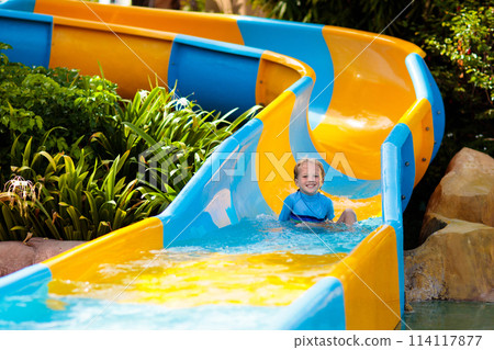 Kids on water slide in aqua park. Summer vacation 114117877