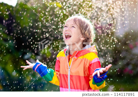 Child playing in autumn rain. Kid with umbrella. Child playing in autumn rain. Kid with umbrella. 114117891