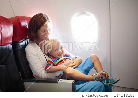 Family in airplane. Mother and child fly. Family in airplane. Mother and child fly. 114118192
