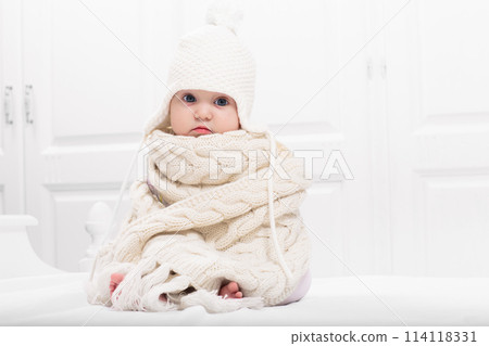 Little baby on white bed 114118331