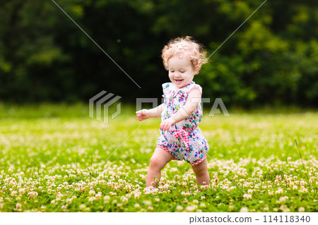 Child in spring park with flowers Child in spring park with flowers 114118340
