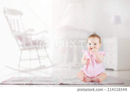 Little baby girl  in white nursery 114118349