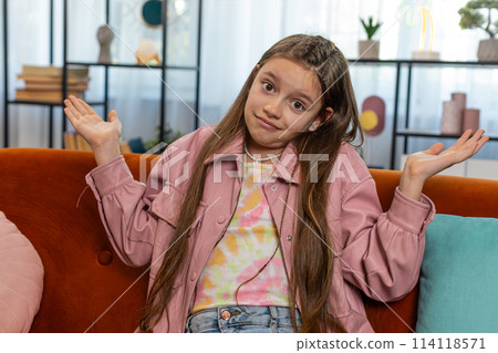 Confused child girl feeling embarrassed about ambiguous question having doubts no idea clueless Confused child girl feeling embarrassed about ambiguous question having doubts no idea clueless 114118571