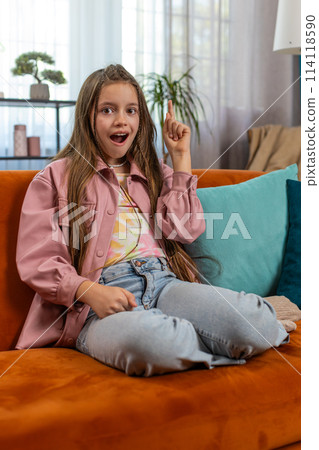 Inspired child girl pointing finger up having good idea plan showing inspiration motivation gesture 114118590