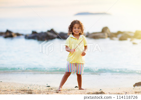 Little boy playing on tropical beach. Little boy playing on tropical beach. 114118726