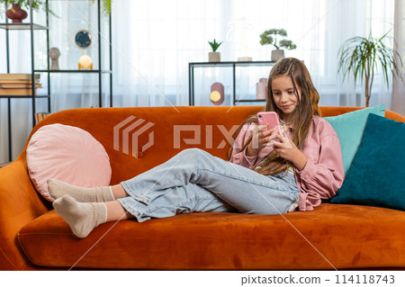 Young girl texting share messages content on smartphone social media applications online at home Young girl texting share messages content on smartphone social media applications online at home 114118743
